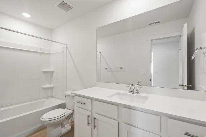 Bathroom featuring a white vanity with an integrated rectangular sink and polished chrome faucet