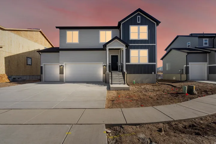 Two-story residence featuring a gray and dark blue facade, white trim, and a covered entry porch