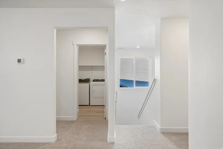 Bright interior with neutral carpeting and white wall finishes