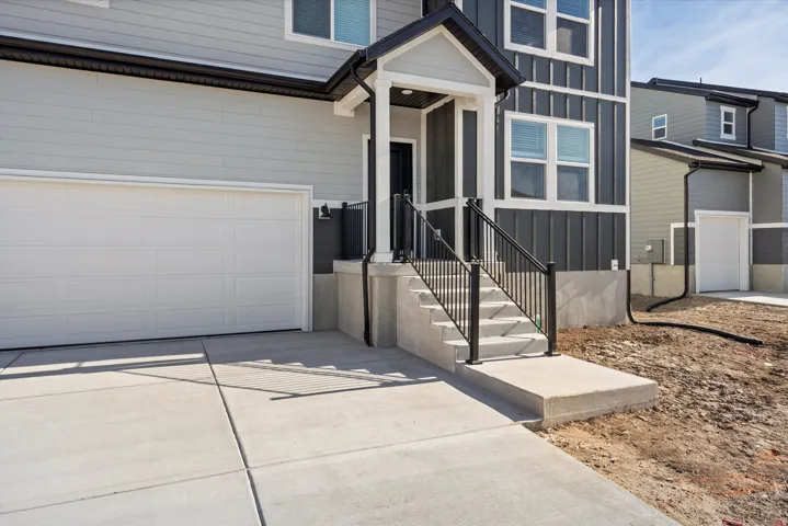 Contemporary exterior featuring light gray siding with dark gray vertical accents
