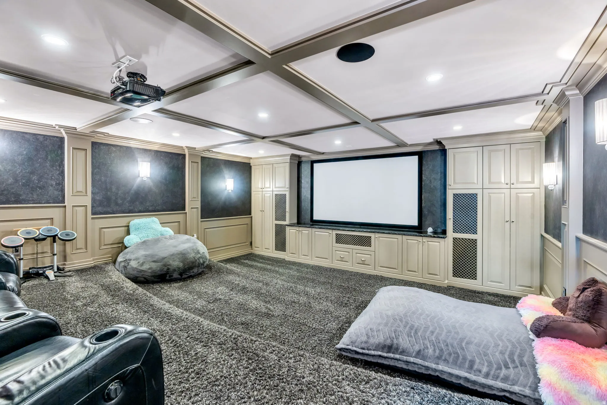 Dedicated media room featuring a large projection screen and ceiling-mounted projector