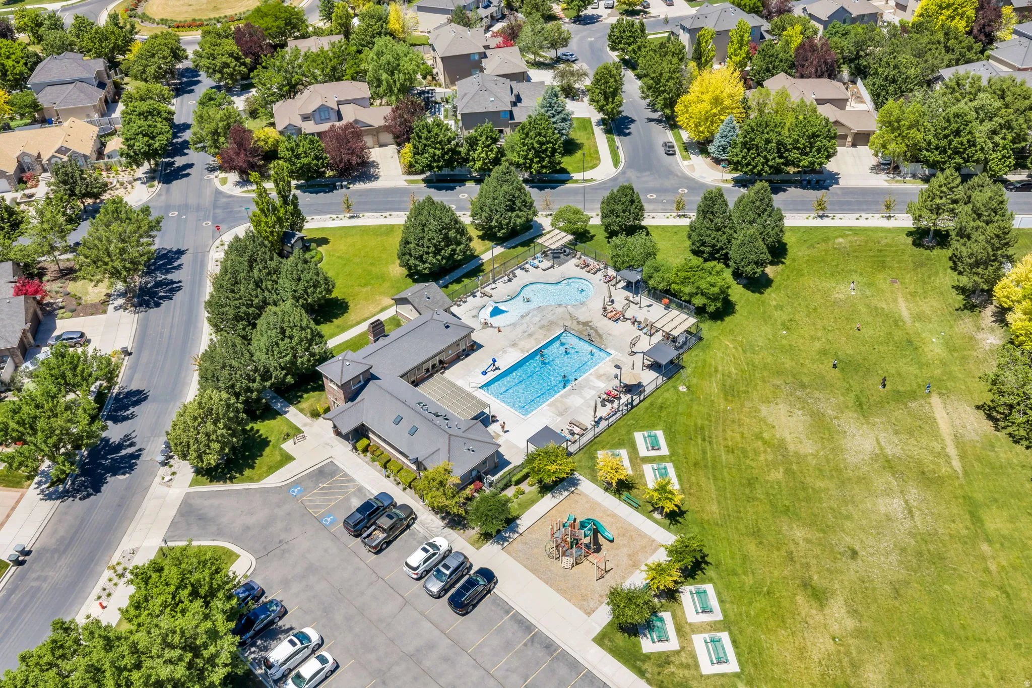 Community recreation area featuring a large swimming pool, separate children's pool, and multiple lounge chairs