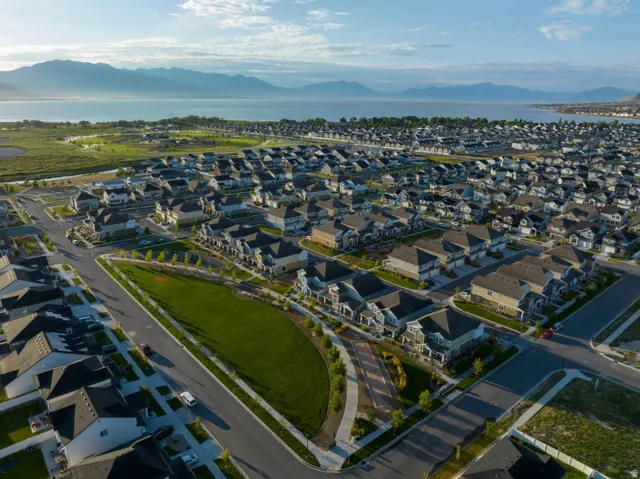 Expansive residential development featuring numerous single-family homes with pitched roofs