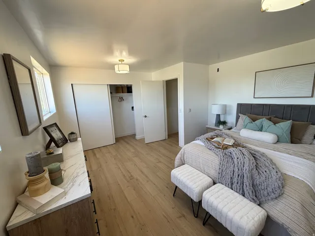Bedroom featuring wood-finish flooring, a double-door closet, recessed lighting, and a ceiling-mounted light fixture
