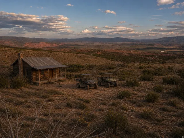 Virtual rendering with cabin and UTVs. Unlimited potential for this 10 acre parcel with breaktaking views.