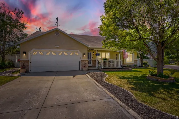Single-story stucco residence with a two-car garage featuring decorative transom windows