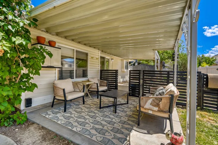 Covered patio featuring a solid roof and concrete flooring