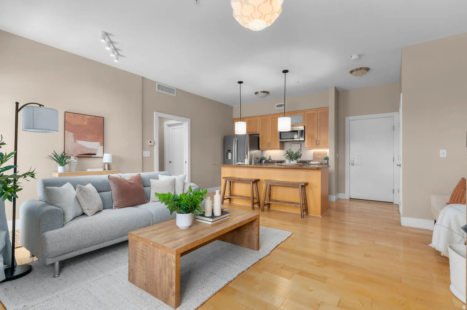 Open-concept living area with wood-finish flooring