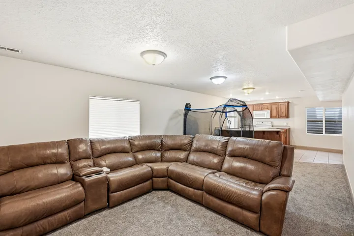 Expansive lower-level space featuring carpeted flooring and recessed lighting
