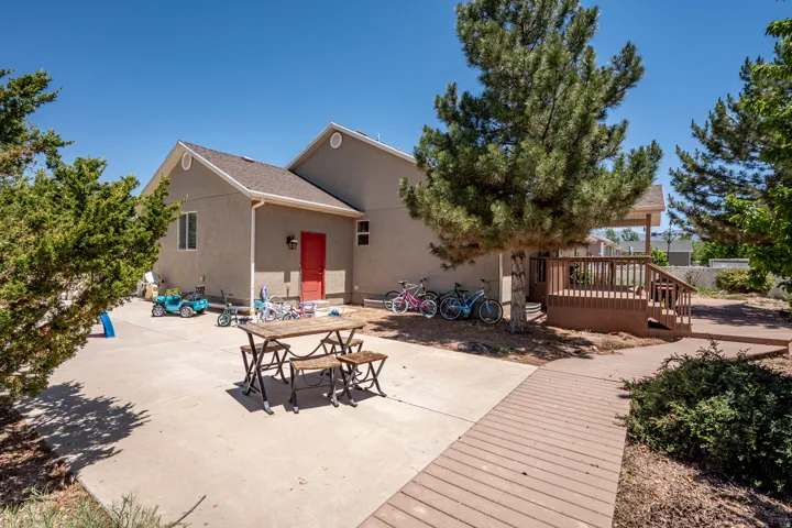 Expansive concrete patio with a wooden deck and walkway