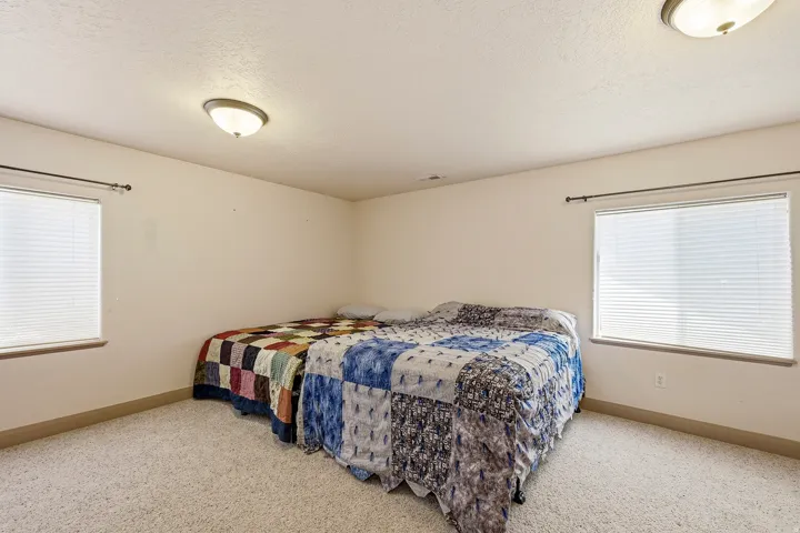 Spacious room featuring neutral carpeting and light-colored walls