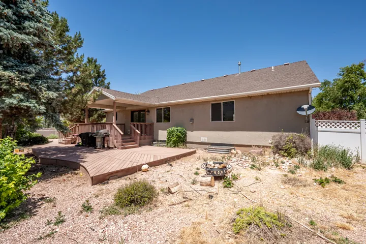 Expansive multi-level wood-finish deck with a covered patio area
