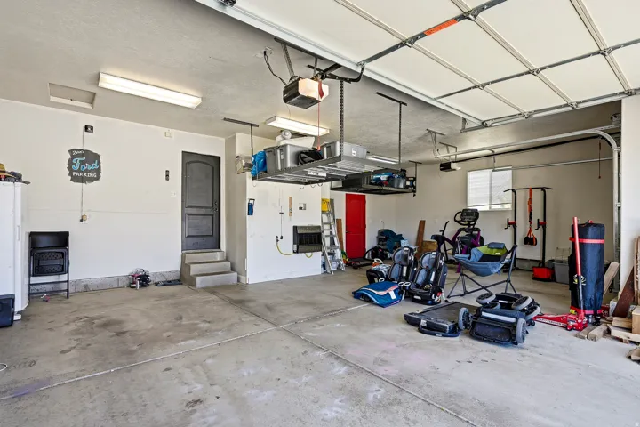 Attached garage with concrete flooring