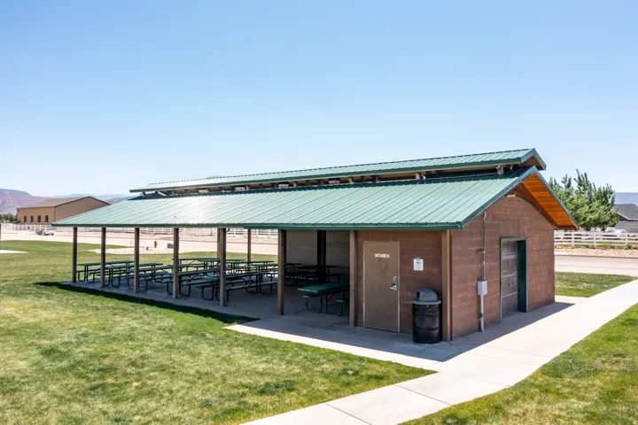 Community pavilion featuring a green metal roof and a concrete block structure