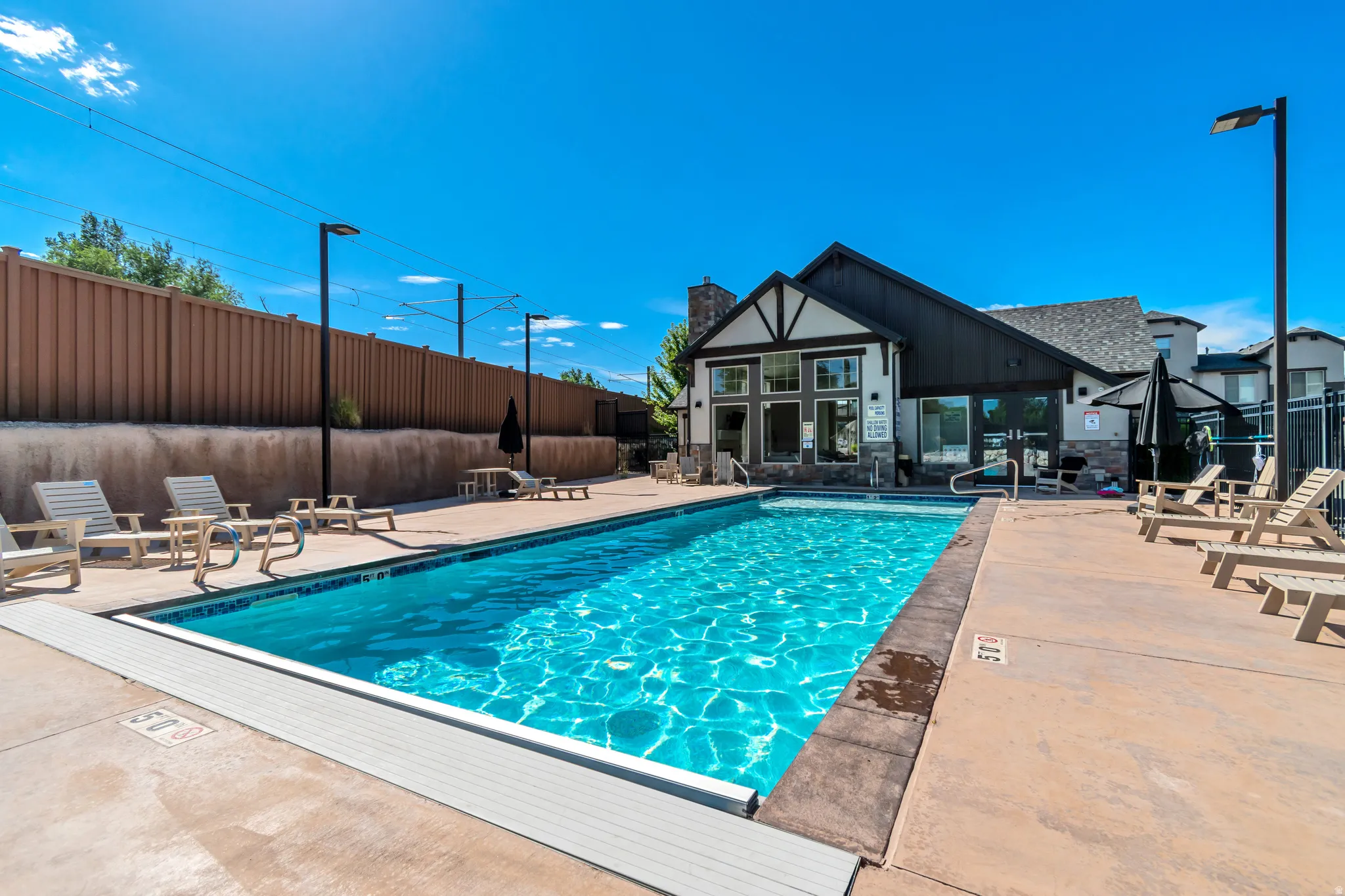 Outdoor swimming pool with concrete decking