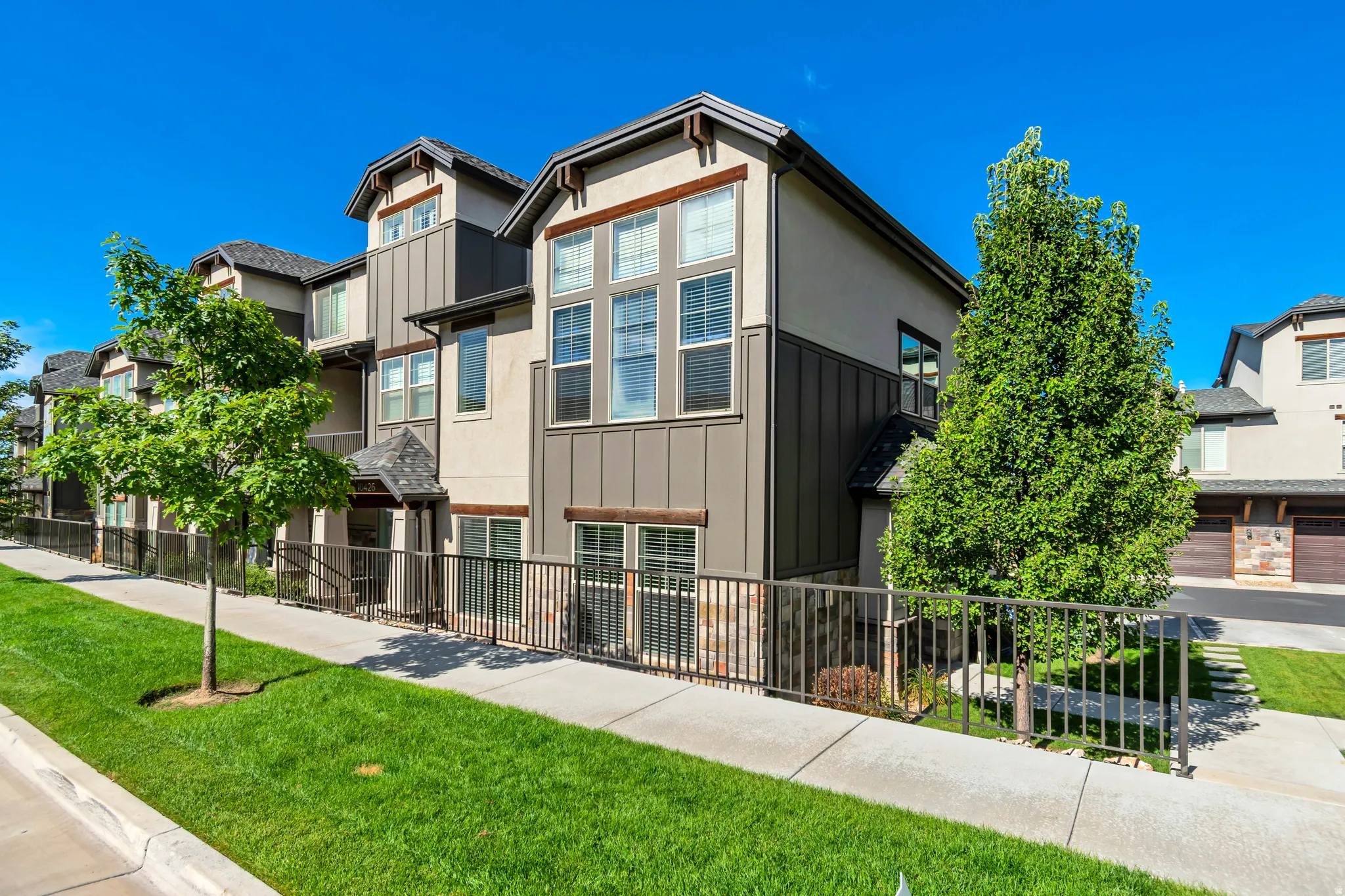 Contemporary multi-level exterior with stucco and vertical siding accents