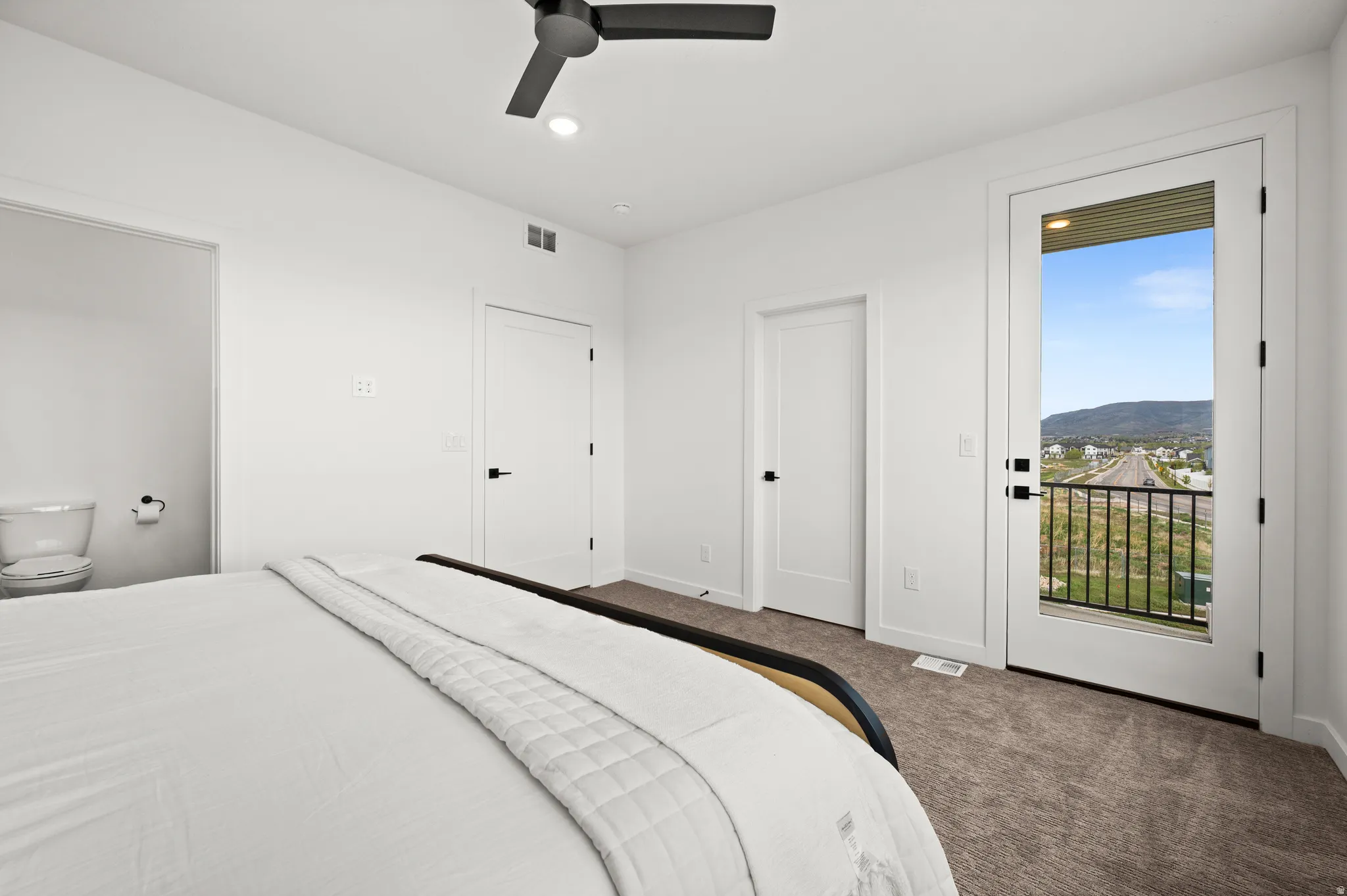 Bedroom featuring neutral carpeting and a modern ceiling fan