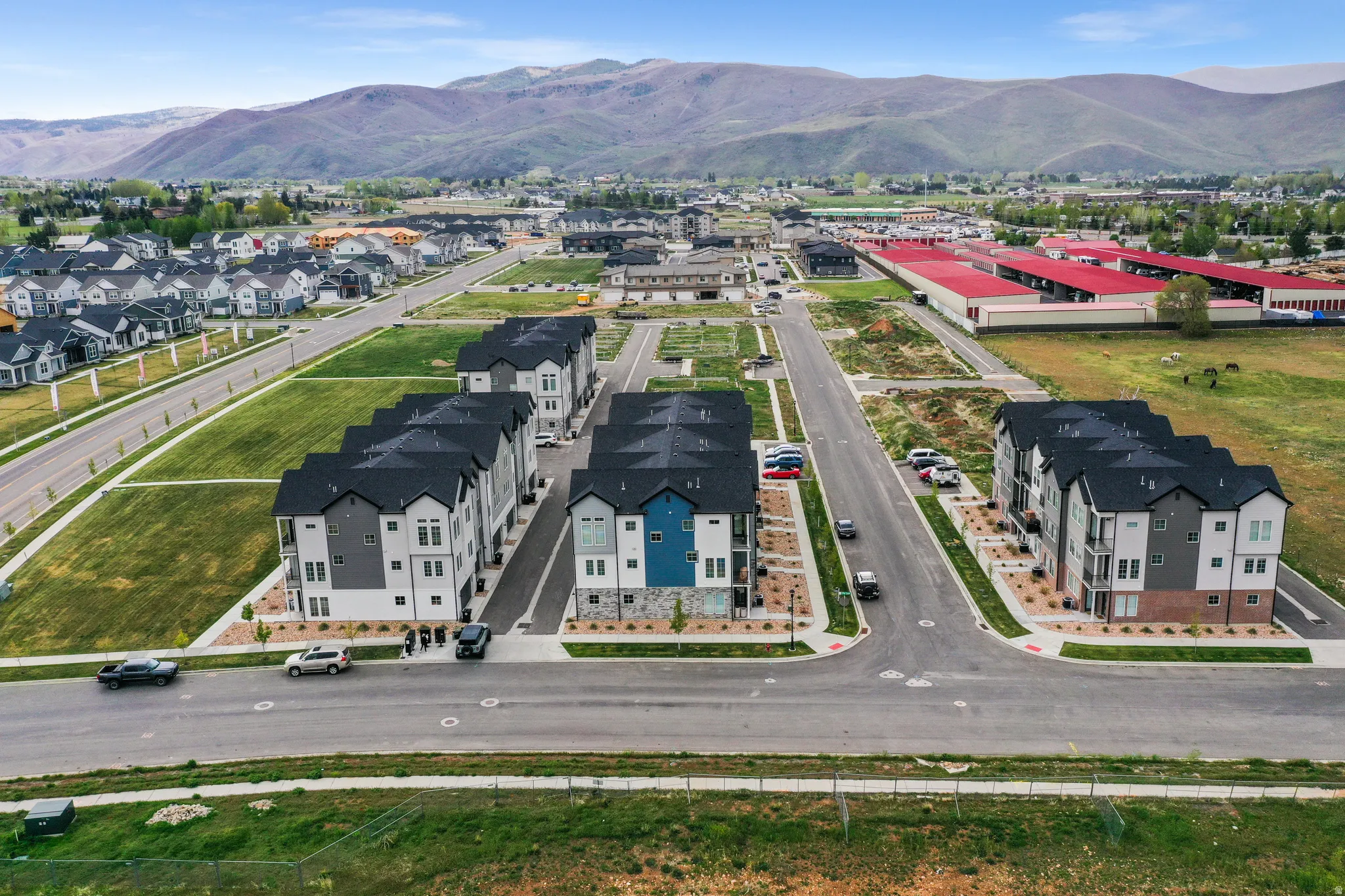 Aerial perspective showcasing a developing residential community with multiple townhome buildings