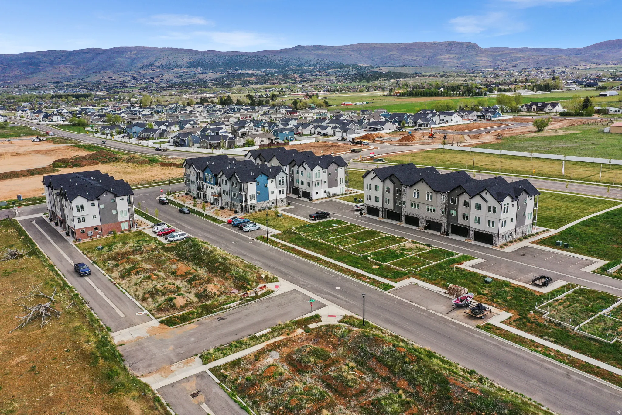 Townhome-style residences featuring multi-level construction, attached garages, and a modern exterior design