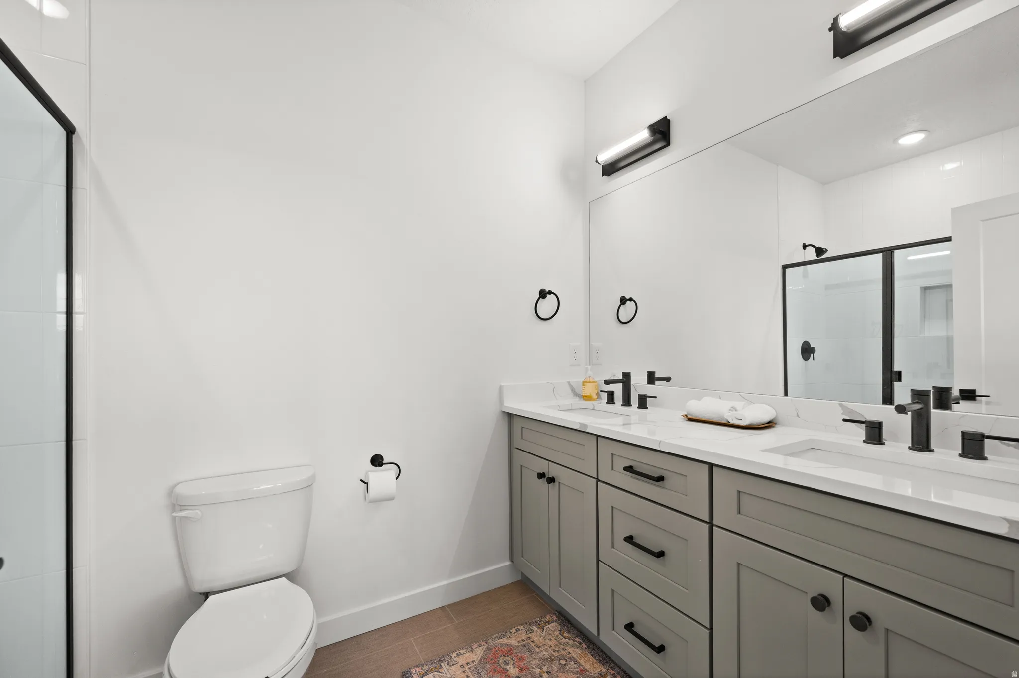 Dual vanity with stone countertops and undermount sinks