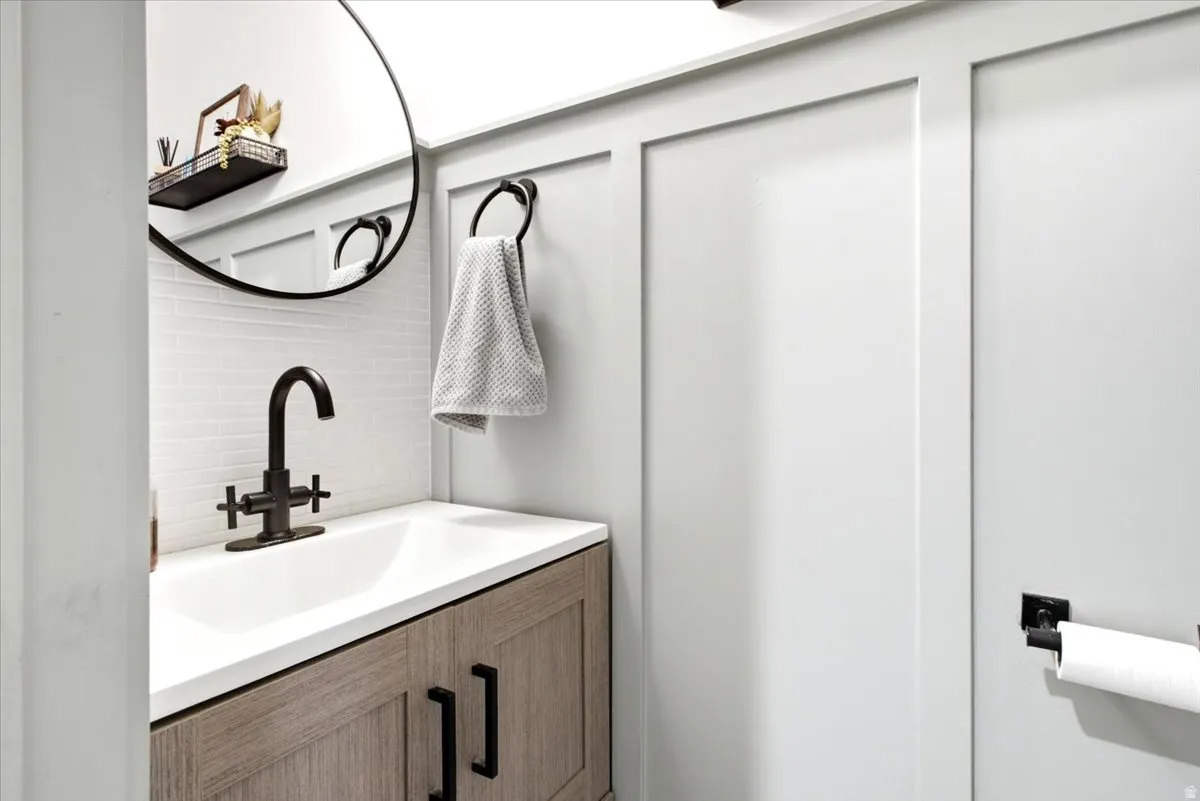 Vanity with a white countertop and wood-finish cabinetry