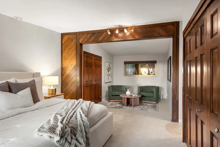 Bedroom space featuring a recessed sleeping area and an adjoining sitting area