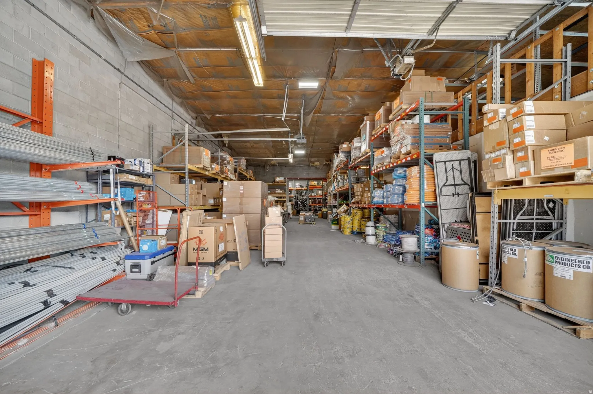 Spacious commercial warehouse featuring concrete block walls and a concrete floor