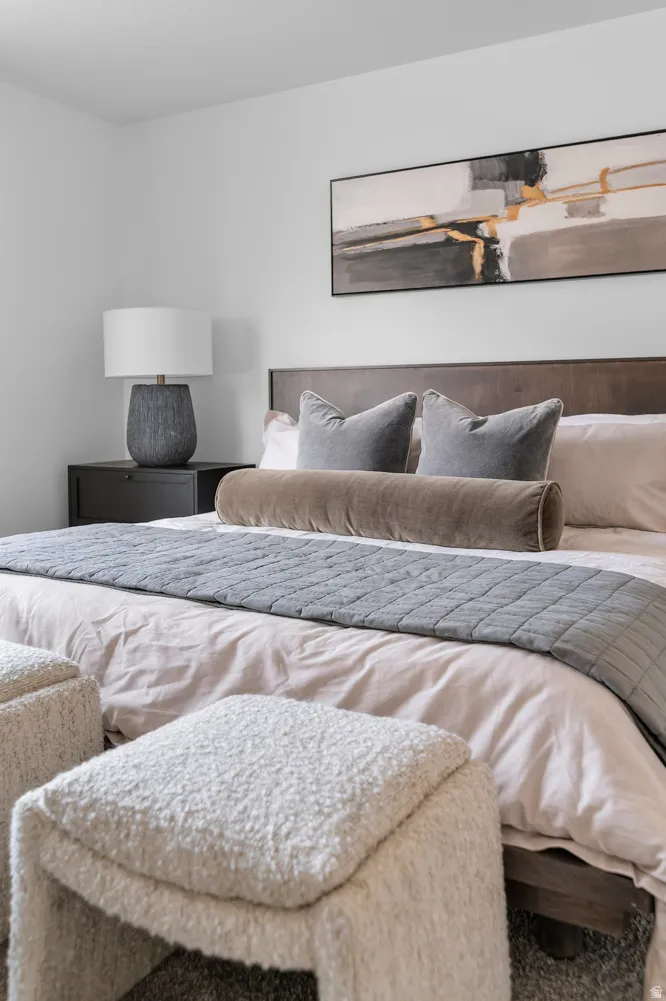 Bedroom featuring a dark wood bed frame, a coordinating dark wood nightstand, and light-toned walls