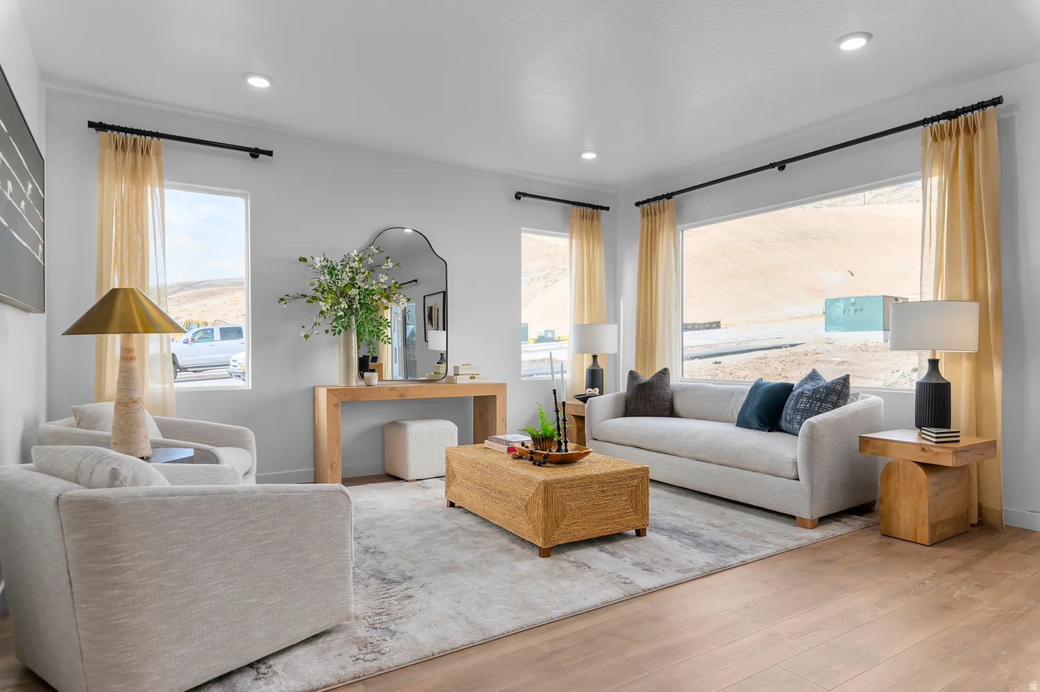 Living area featuring wood-finish flooring, recessed lighting, and expansive windows