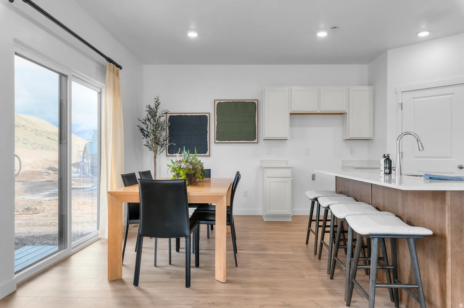 Open-concept living space with wood-finish flooring