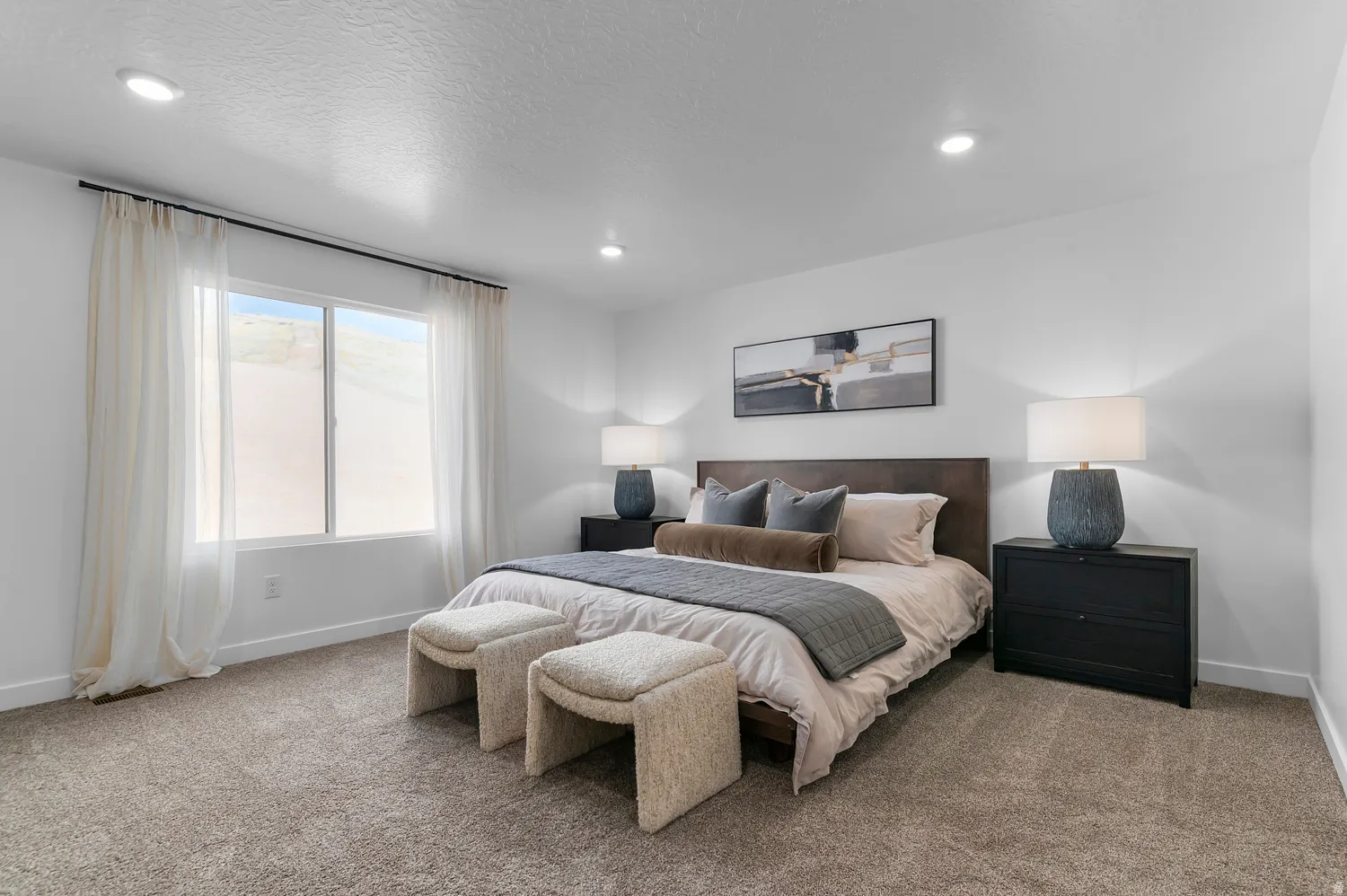 Spacious interior featuring neutral-toned carpet flooring and recessed lighting