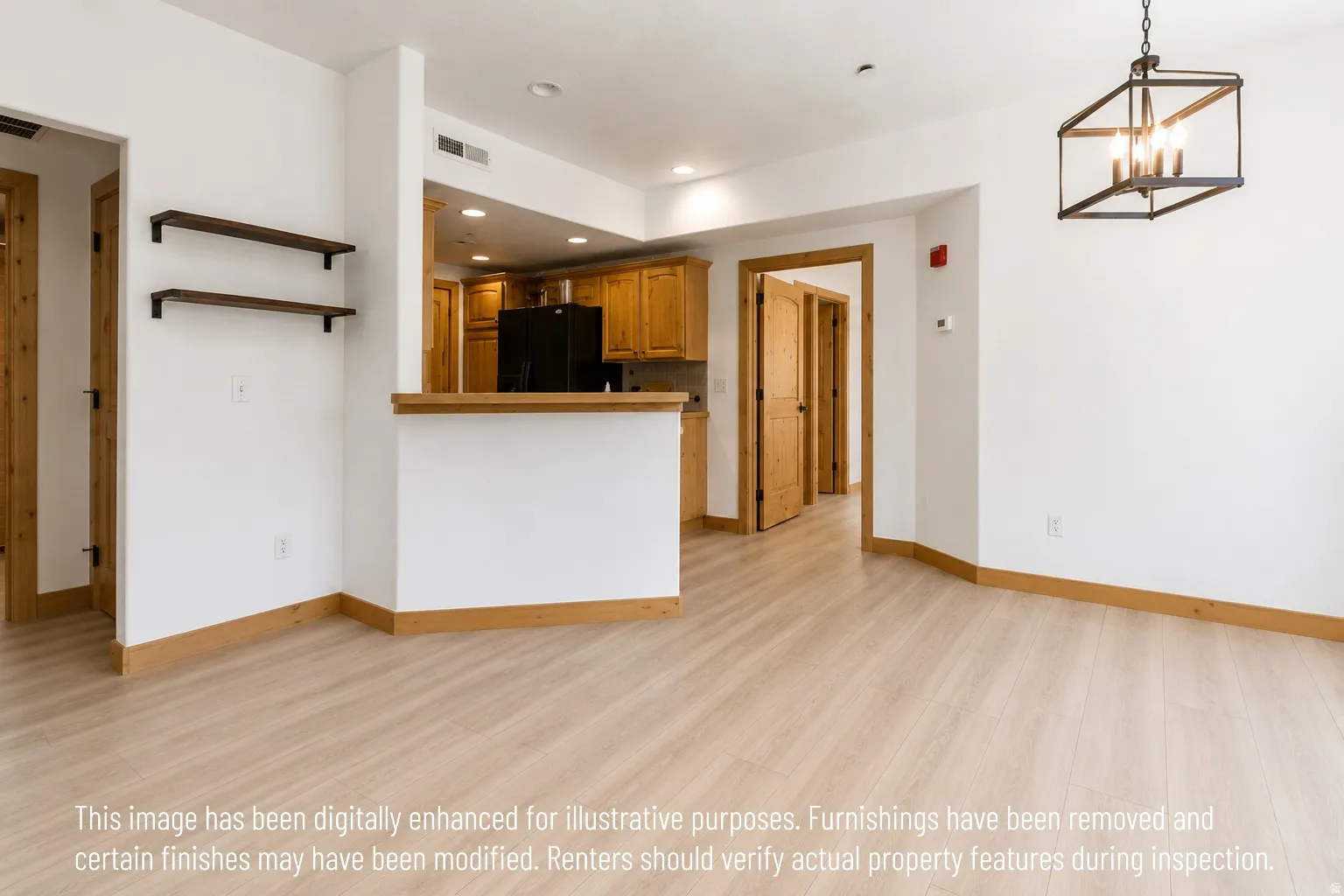 Open concept living area featuring light wood-finish flooring, white walls, and natural wood trim throughout
