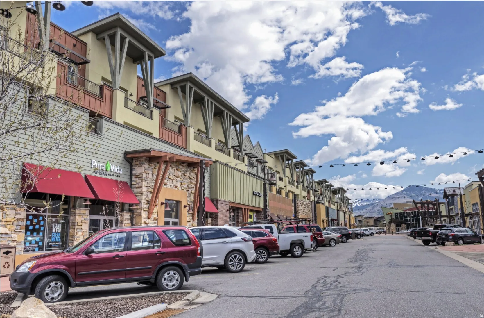 Multi-story commercial building featuring varied exterior finishes including stone veneer, horizontal siding, and stucco