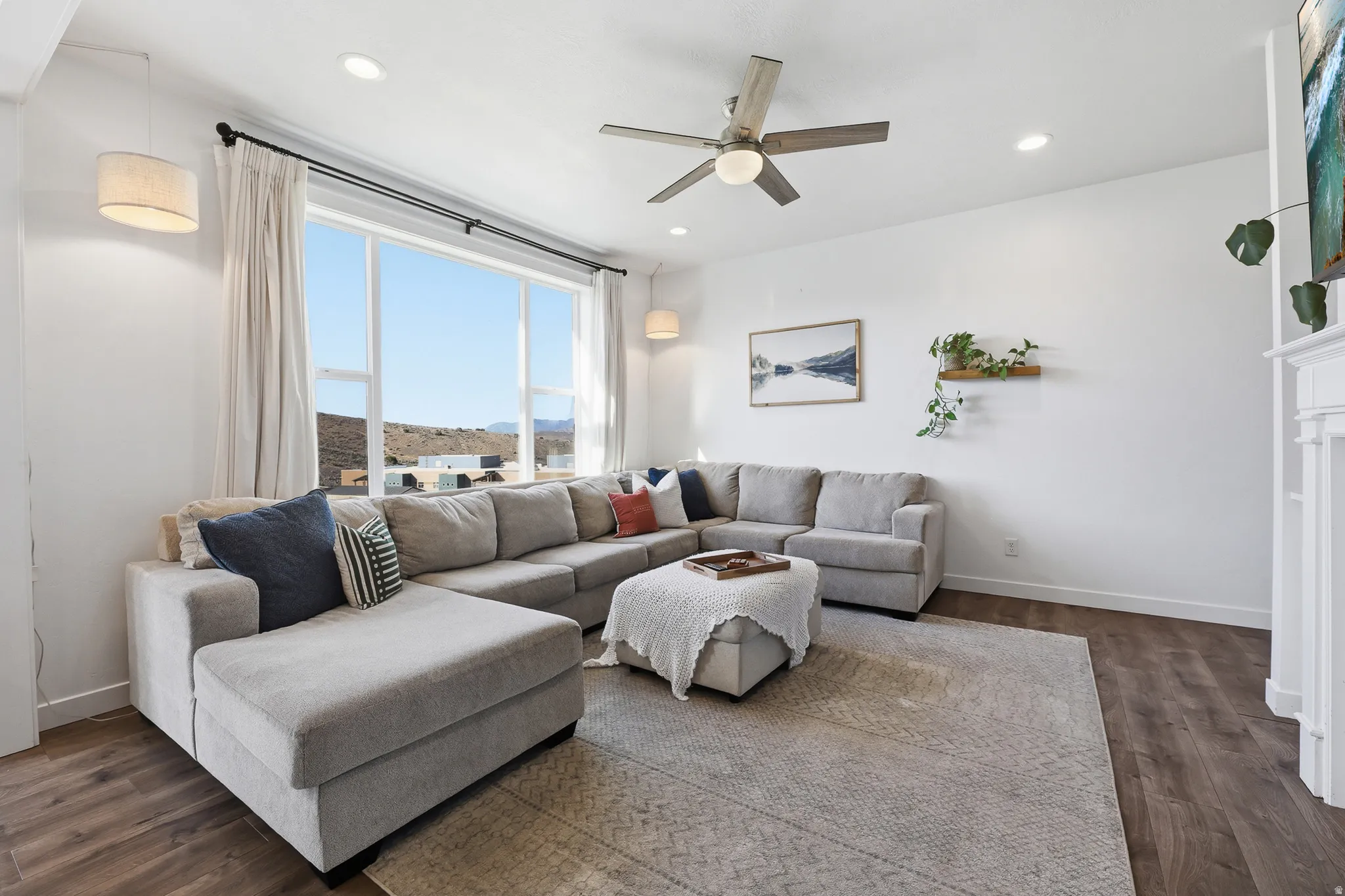 Living area featuring ample natural light, recessed lighting, wood-finish flooring, a ceiling fan, and a built-in fireplace mantle