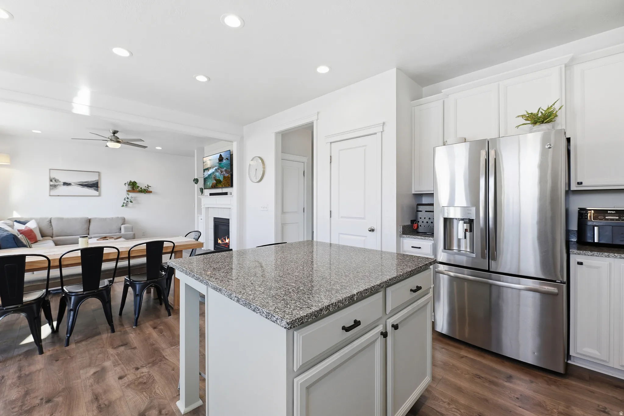 Kitchen island with a granite-style countertop and integrated cabinetry
