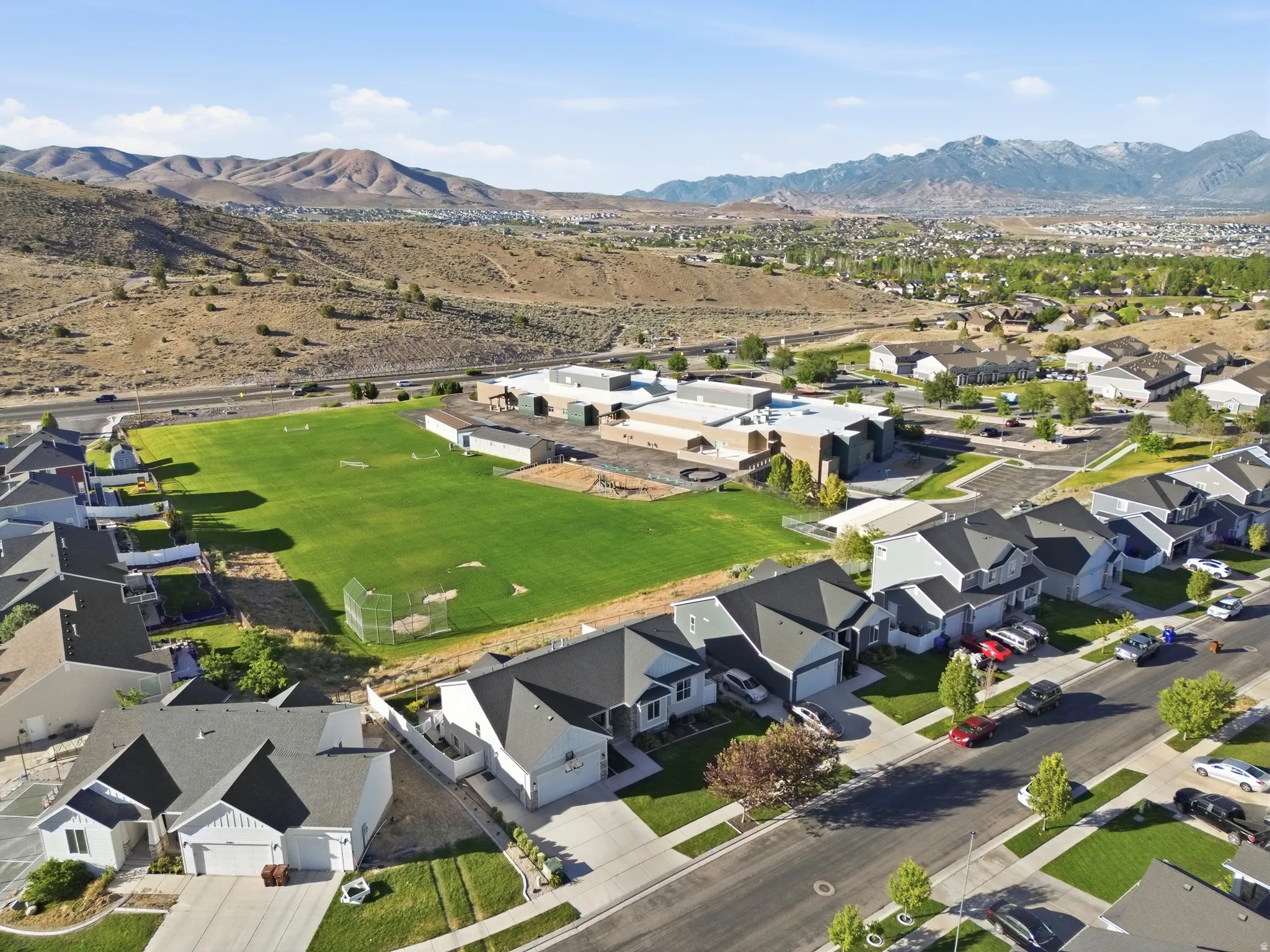 Residential neighborhood featuring single-family homes with dark roofs and light-colored siding