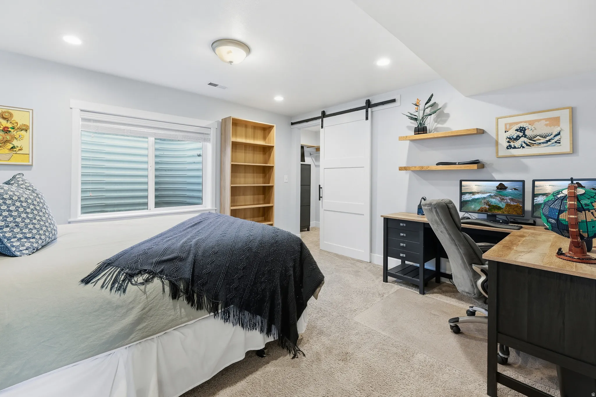 Spacious room featuring light-colored walls, recessed lighting, and soft carpet flooring