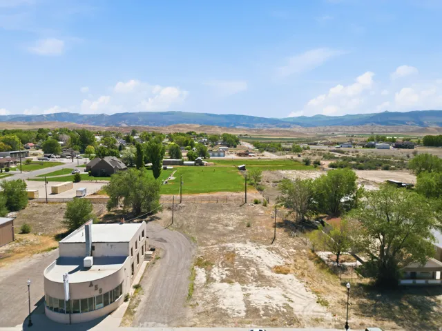 Expansive lot offering significant frontage and depth, featuring a gravel drive and perimeter fencing
