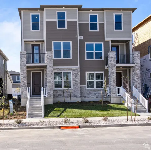 Modern multi-story facade featuring stone veneer and horizontal siding