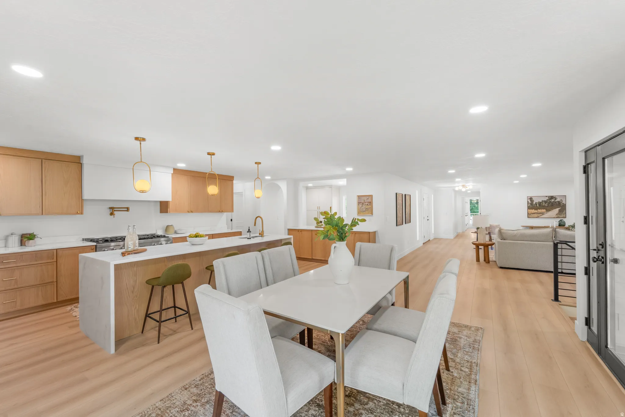 Open-concept living space featuring light wood-finish flooring throughout