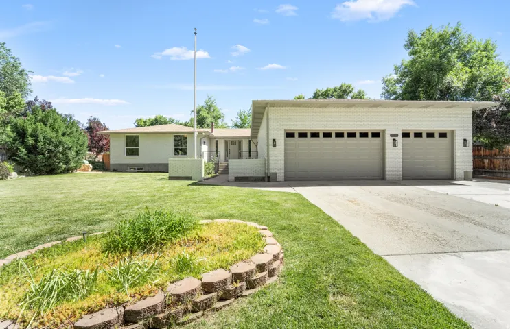 Ranch-style residence featuring a white brick exterior and a flat roofline