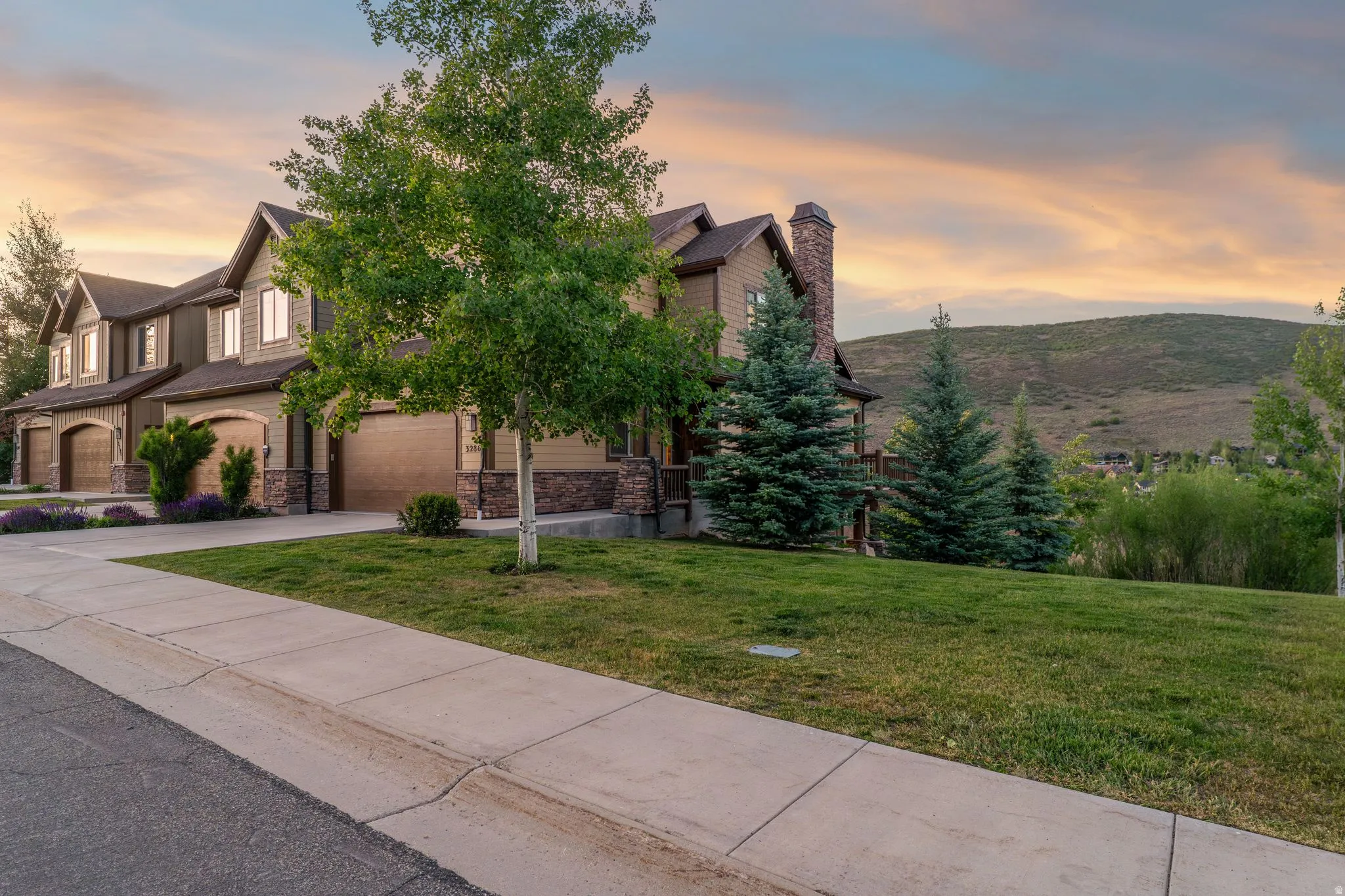 Brown-toned residence with stone accents and a prominent chimney