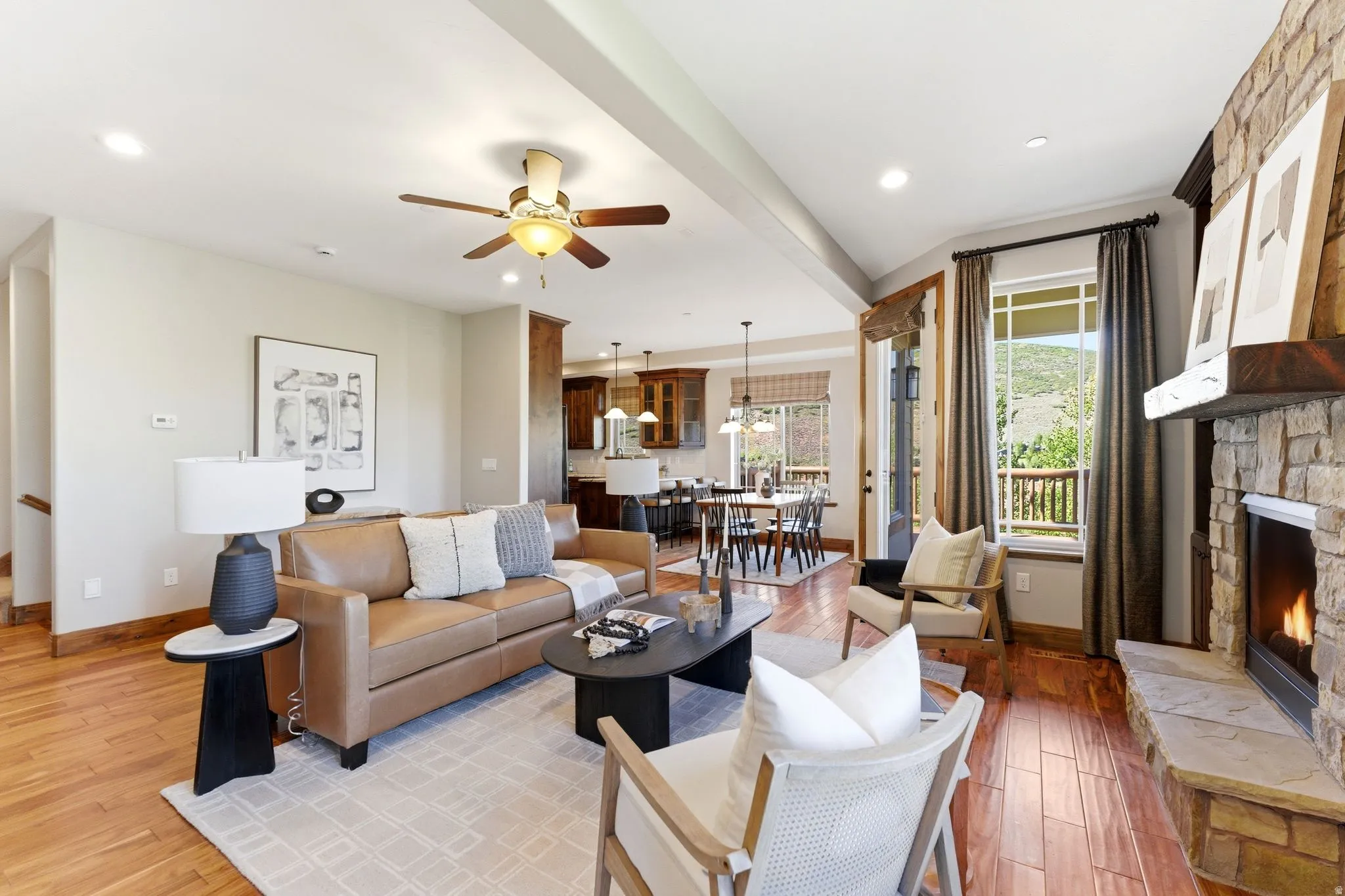 Expansive living area featuring wood-finish flooring, recessed lighting, and a ceiling fan