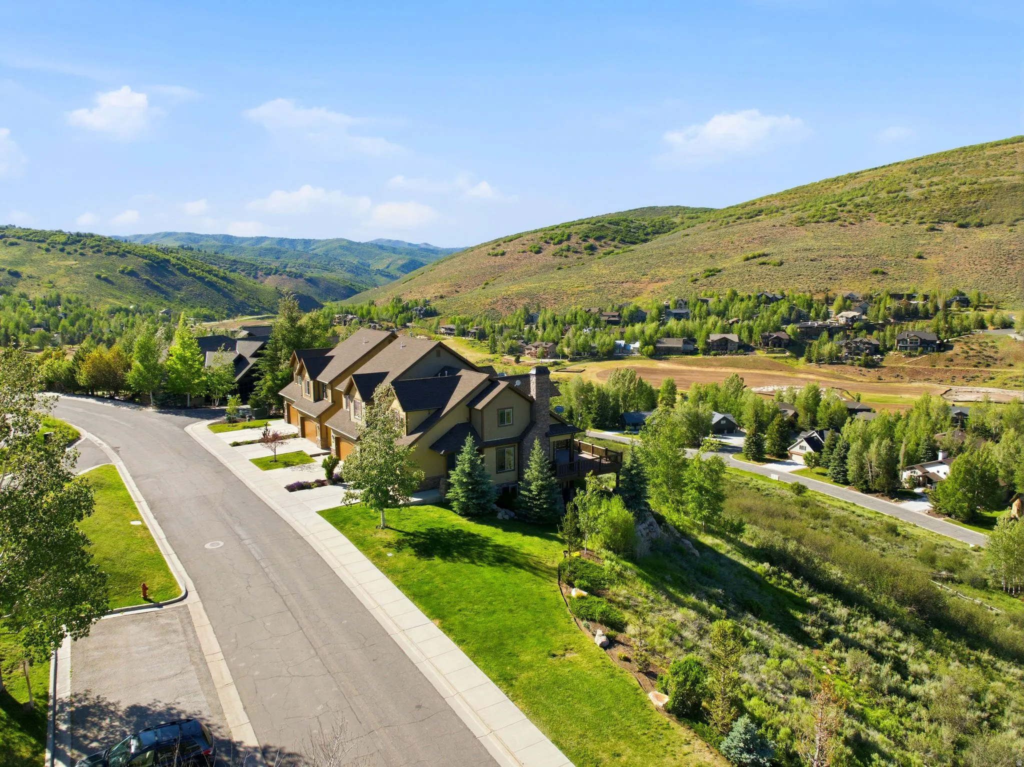 Expansive residential property featuring a multi-level structure with a gabled roofline and attached two-car garage