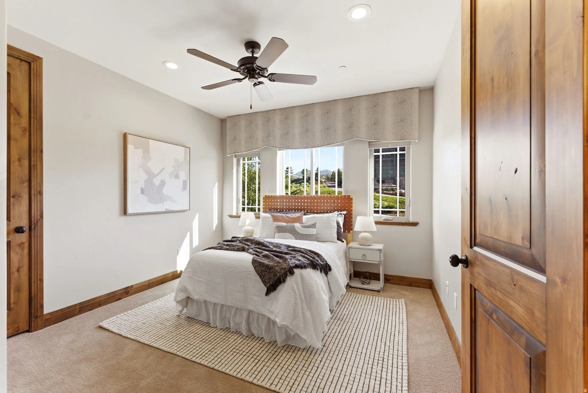 Carpeted room featuring natural wood doors and trim, recessed lighting, and a ceiling fan