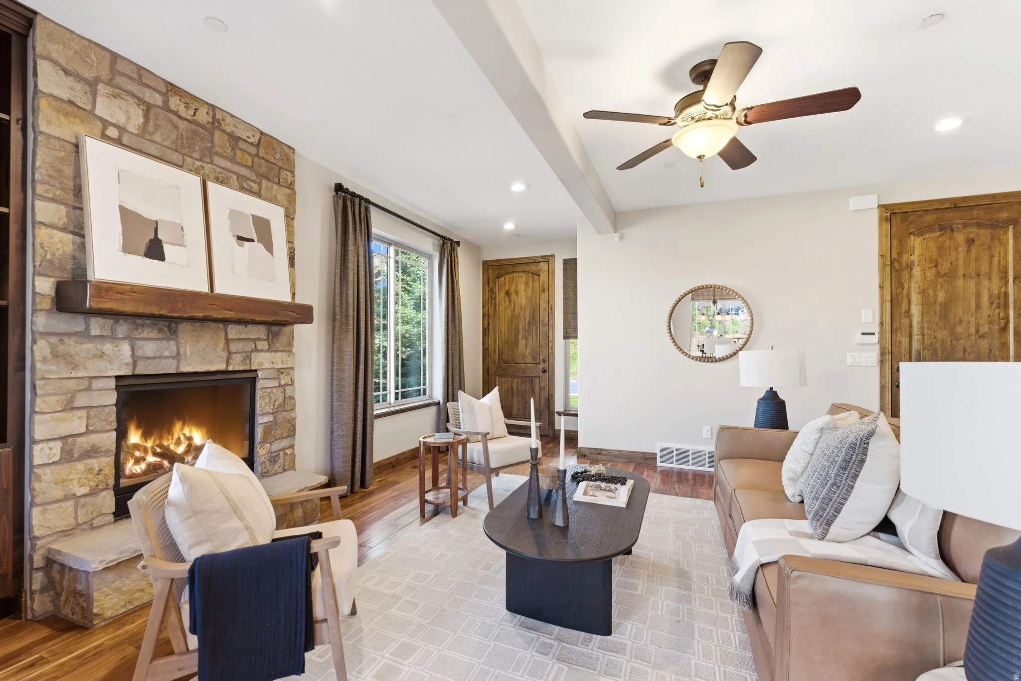 Stone fireplace with a substantial wood mantel