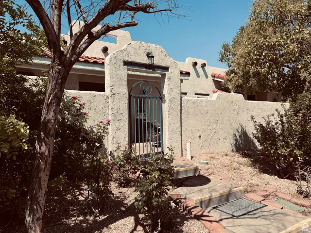 Southwestern-style exterior featuring a stucco finish and a terracotta tile roof