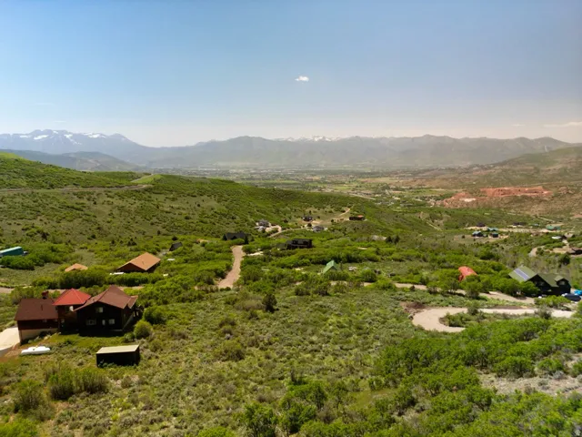 View from the direction of the 1 ac.lot which is between the home on the left and the driveway on the right