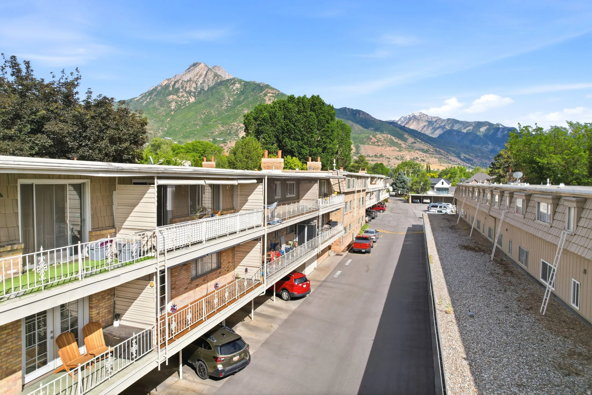 Multi-story apartment building with beige siding and brick accents