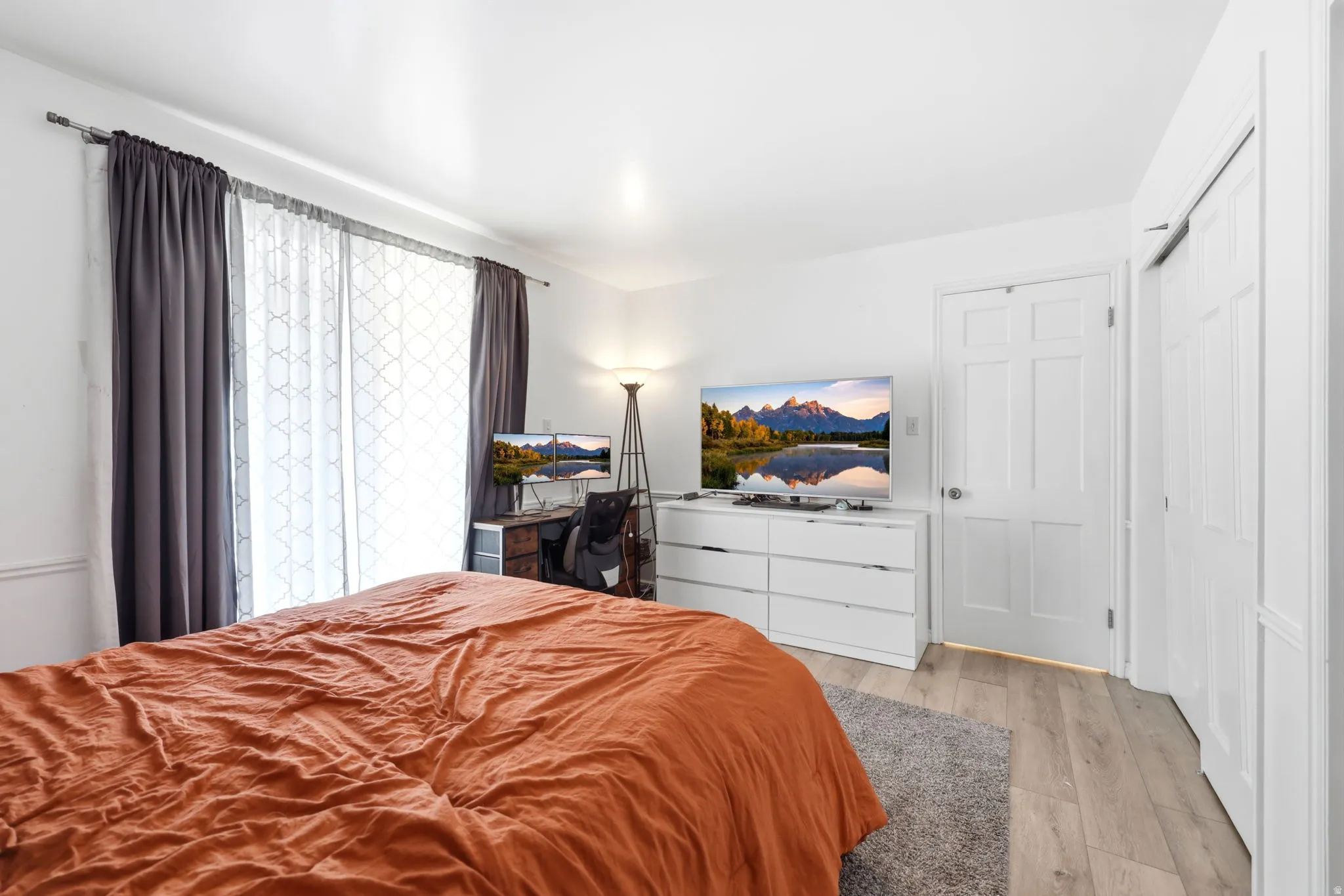 Bright room featuring light wood-finish flooring and white walls